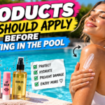 Woman applying mineral sunscreen by the pool with skincare and hair protection products displayed on a towel